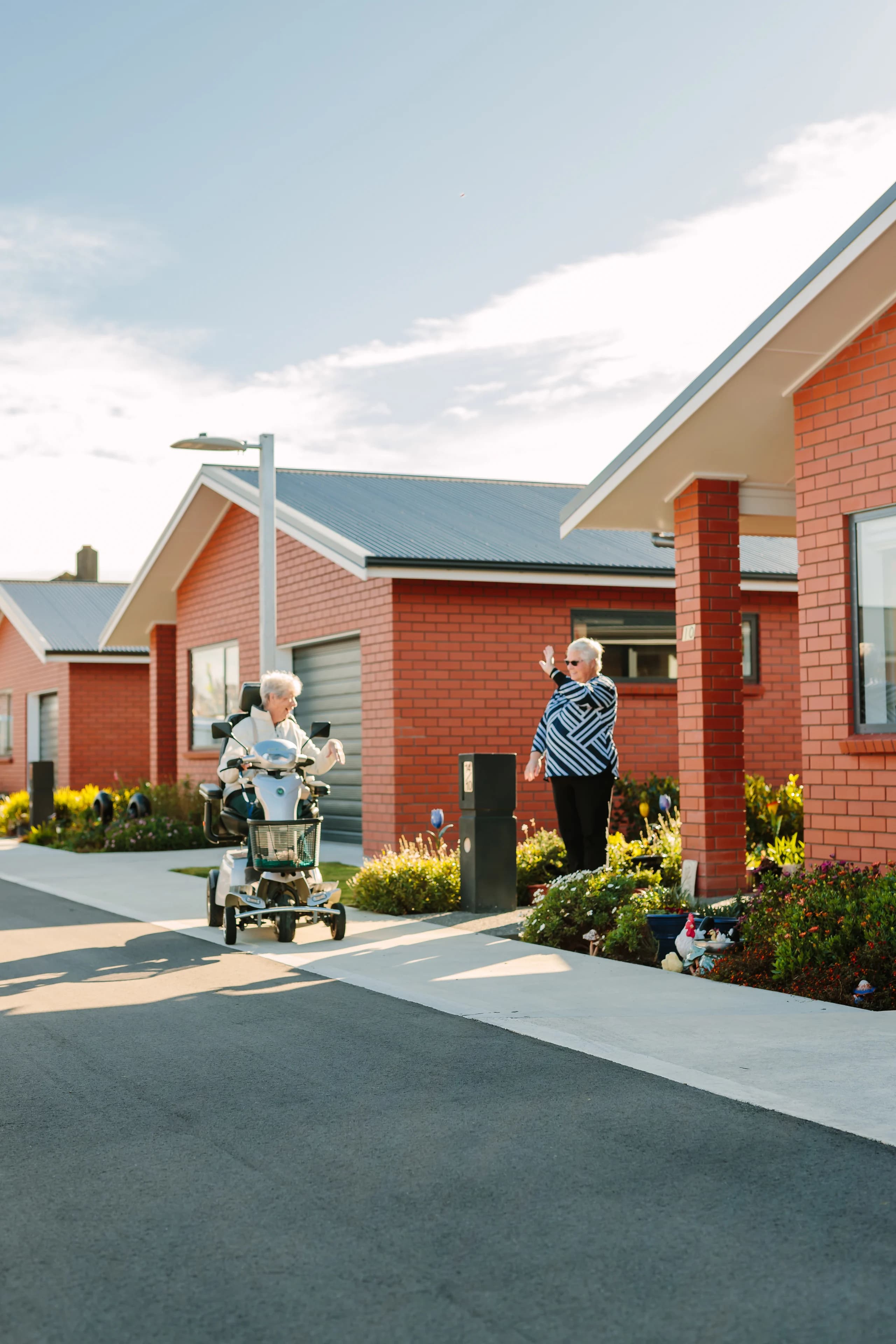 Neighbours greeting each other on a sunny village path