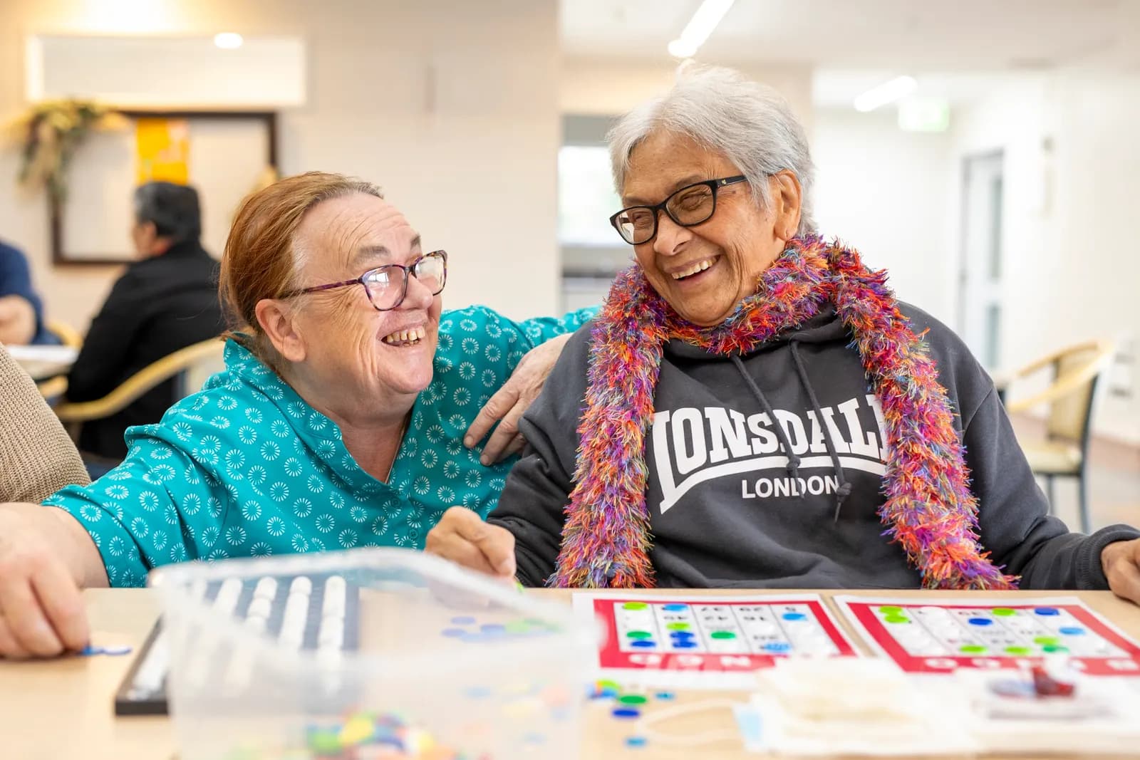 An Aldwins House resident and team member enjoying a tabletop activity