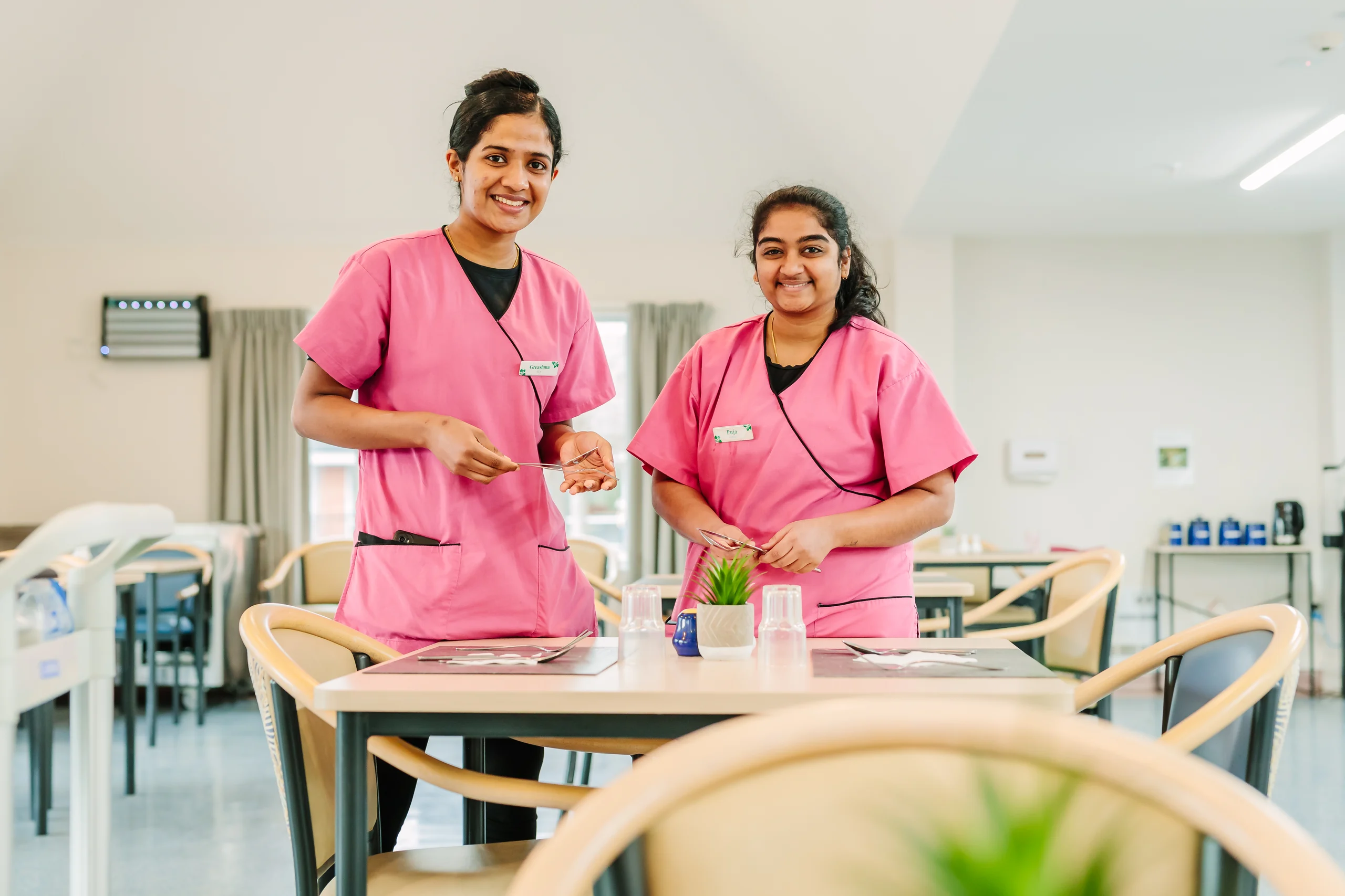 Two Promisia team members in a shared dining room