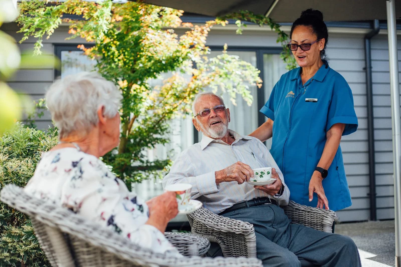 Chatswood residents sharing tea and conversation with a team member outdoors