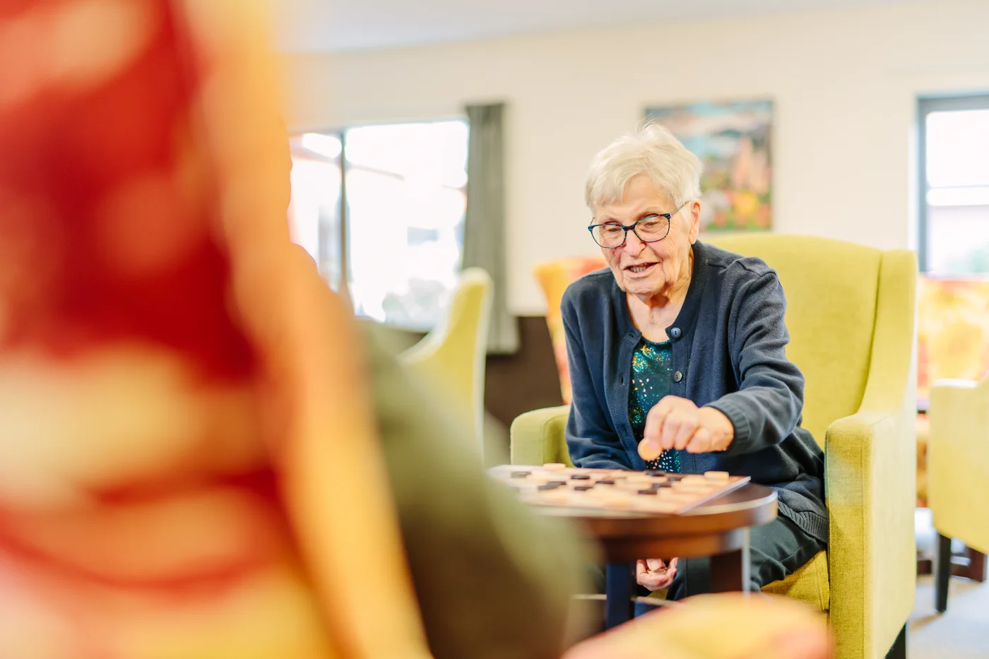 A Promisia resident enjoying a tabletop game