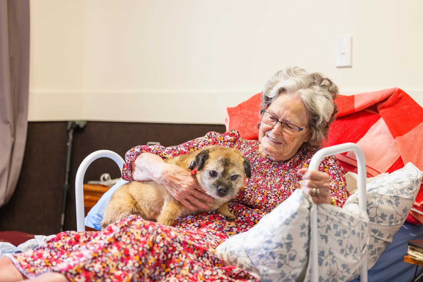 A Ranfurly Manor resident relaxing with a visiting dog